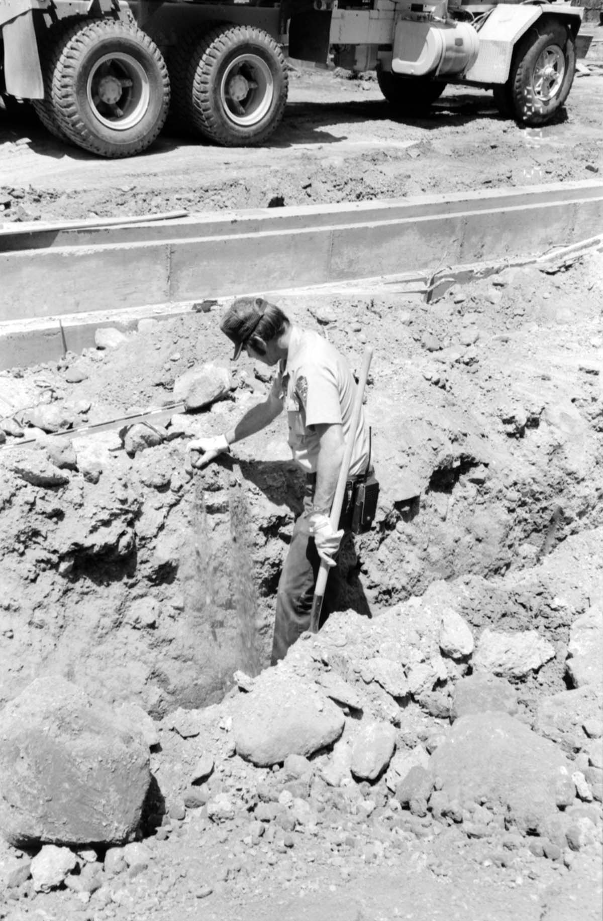Man worker using shovel during the construction of headquarters addition.