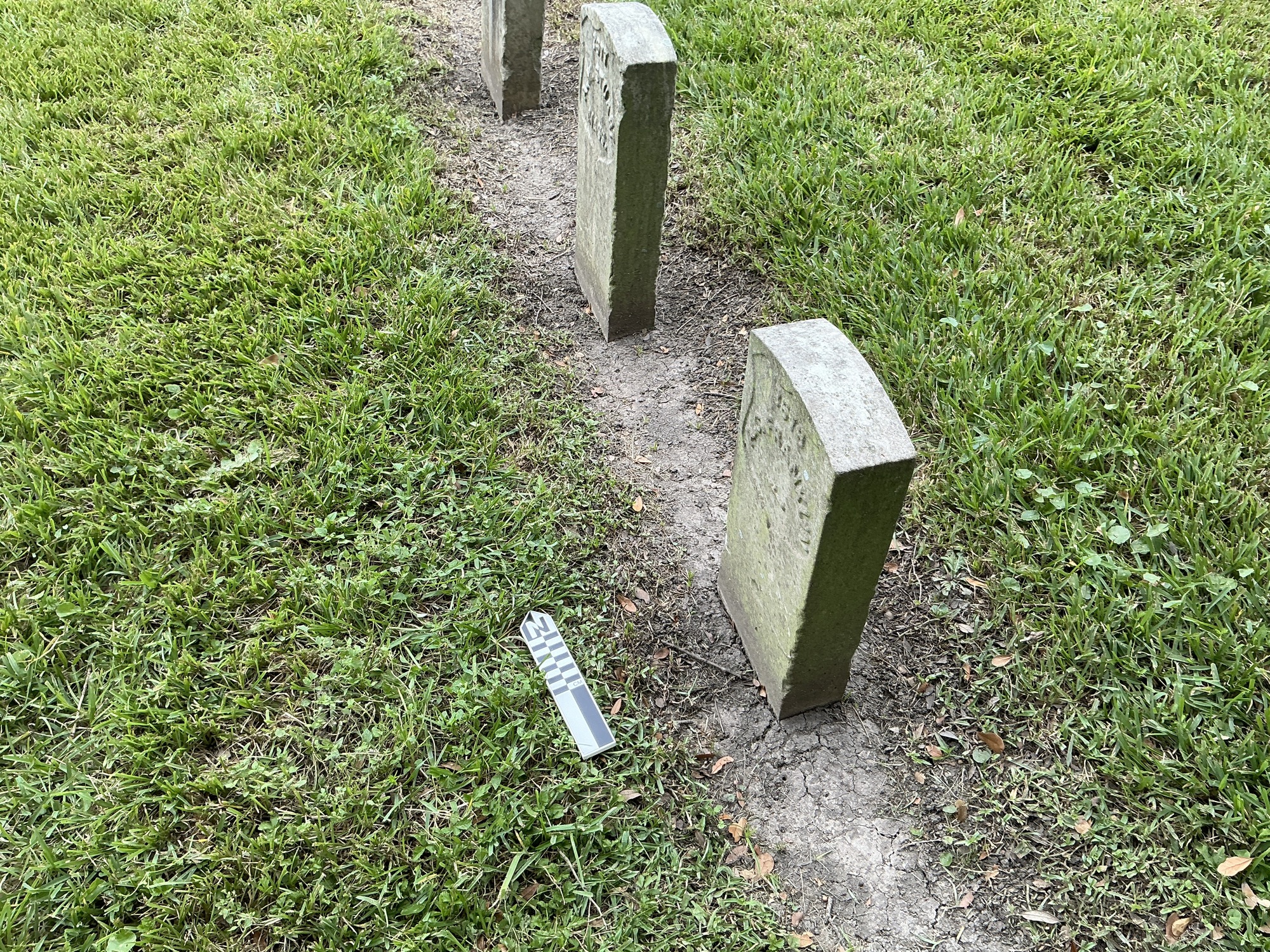 Extra image of historic upright marble headstone with recessed shield with recessed lettering face.