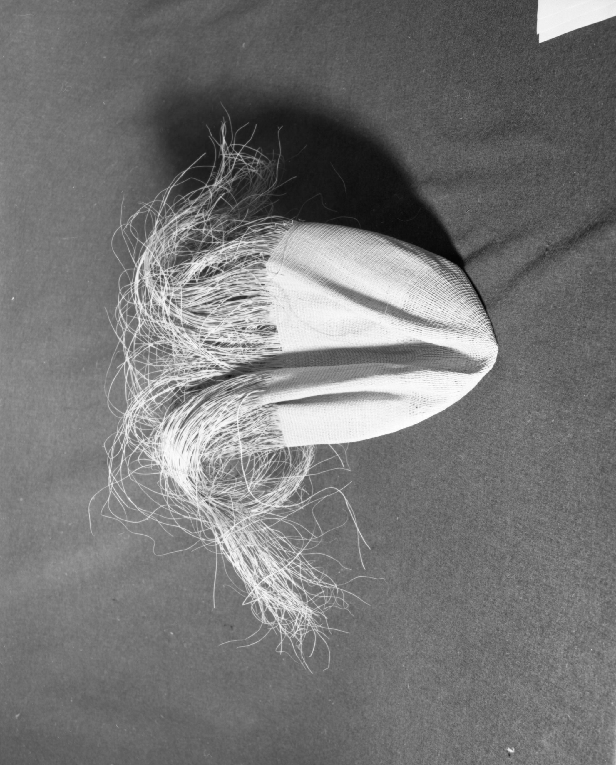 Marie Rozier Collection, Catalog No. 5-9-FM. Object: Unfinished Aleut bag. Dimensions: 1' x 2' approximate. Materials: seagrass, Technology: plain and diagonally twined, down to right slant of turns. Collection History: Gift of Flora Hill McCullough. Photographed by Michael Dixon, December 1982. Catalogued by Craig Bates and Barbara Beroza. Yosemite Collections, National Park Service.