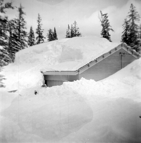 BW Photos showing rangers digging out the visitor center from snowdrift.