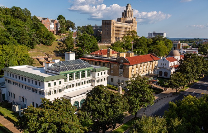 A view of some of the bathhouses, Maurice, Fordyce, and Quapaw on Bathhouse Row. The old army hospital can be seen towering behind