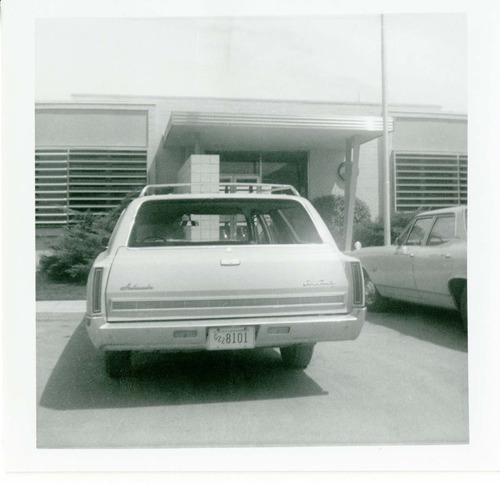 Vehicle parked in parking lot of the old Mission 66 Visitor Center and Museum.