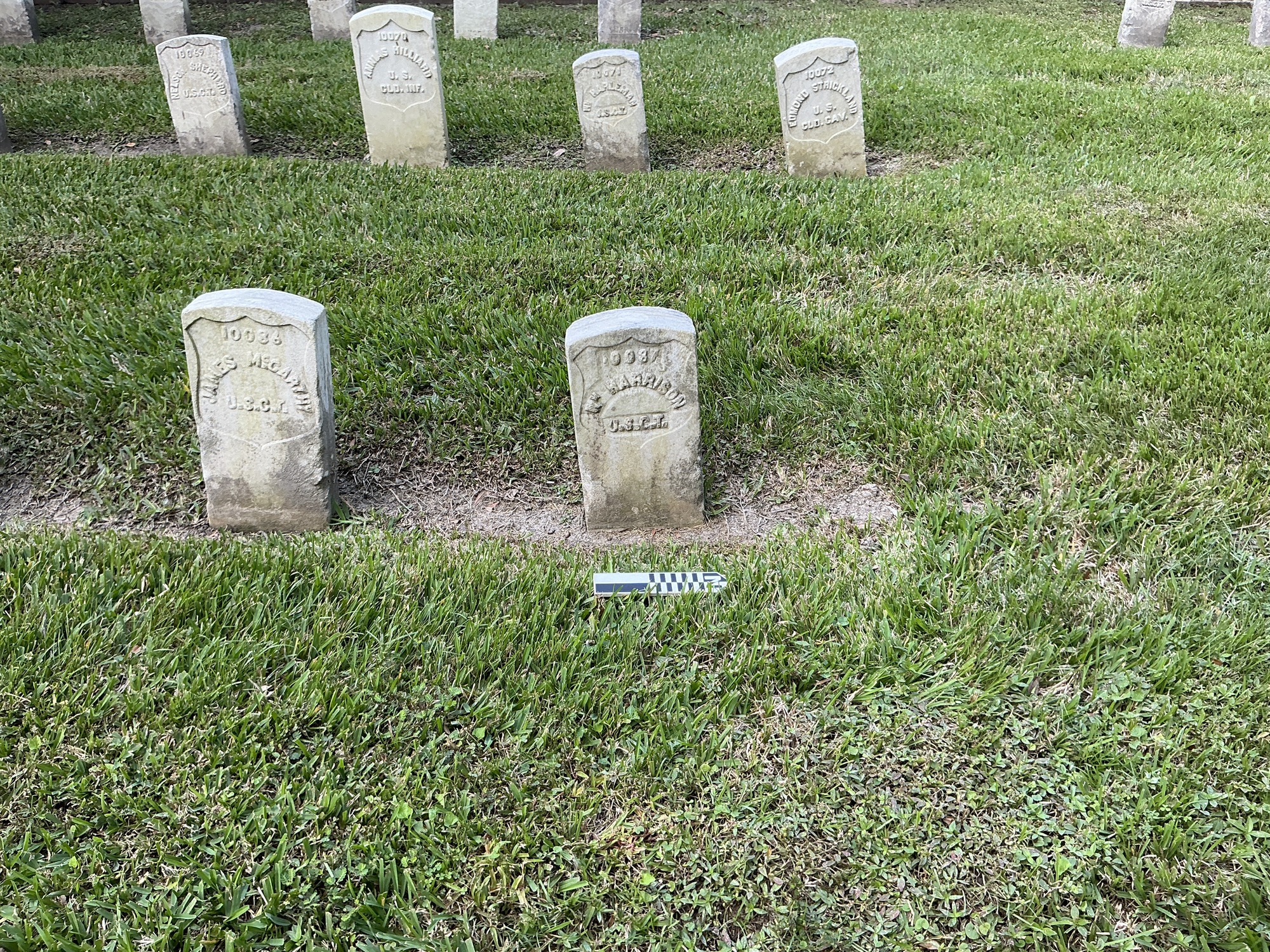 Extra image of historic upright marble headstone with recessed shield with recessed lettering face.