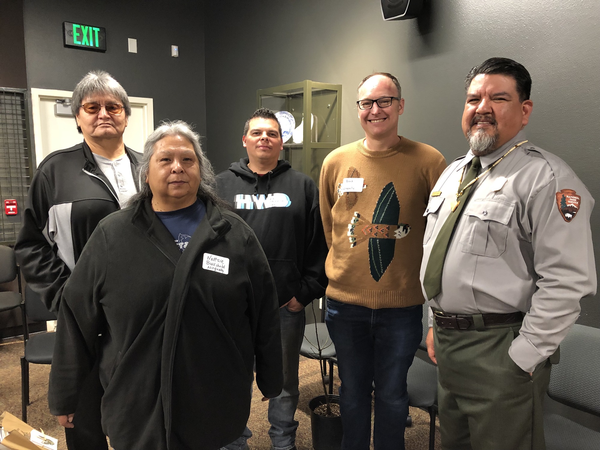 Director Sams in NPS uniform poses with three men and one woman.