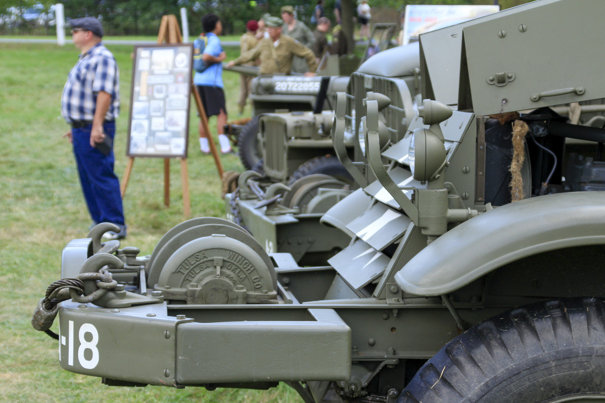 1940s era military vehicles in a line.
