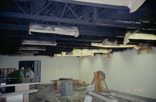 Park Headquarters Renovation: two men working in west corner warehouse, lower level.