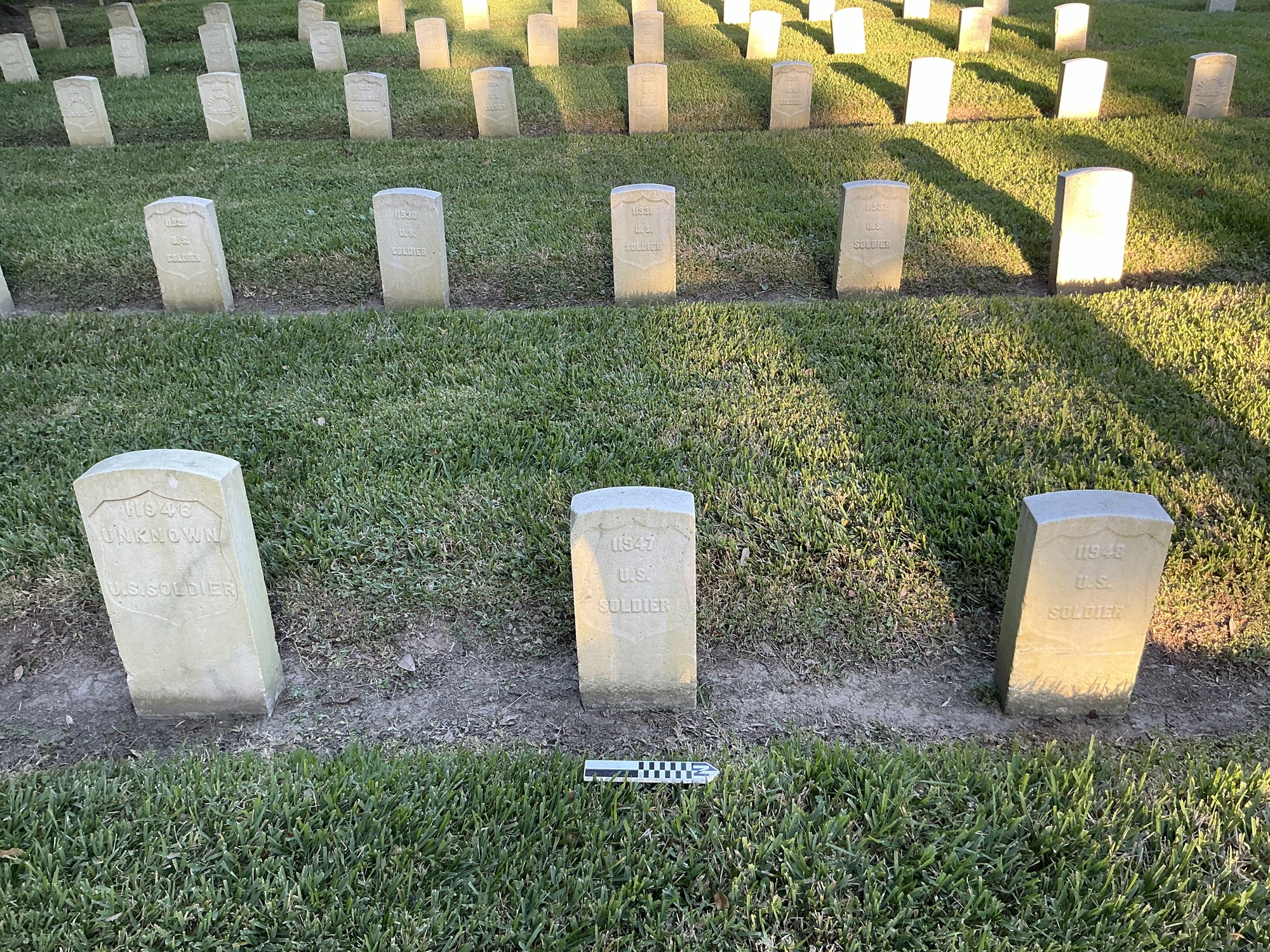 Extra image of historic upright marble headstone with recessed shield face.
