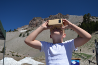 A young visitor uses a special viewer to enjoy a 360 