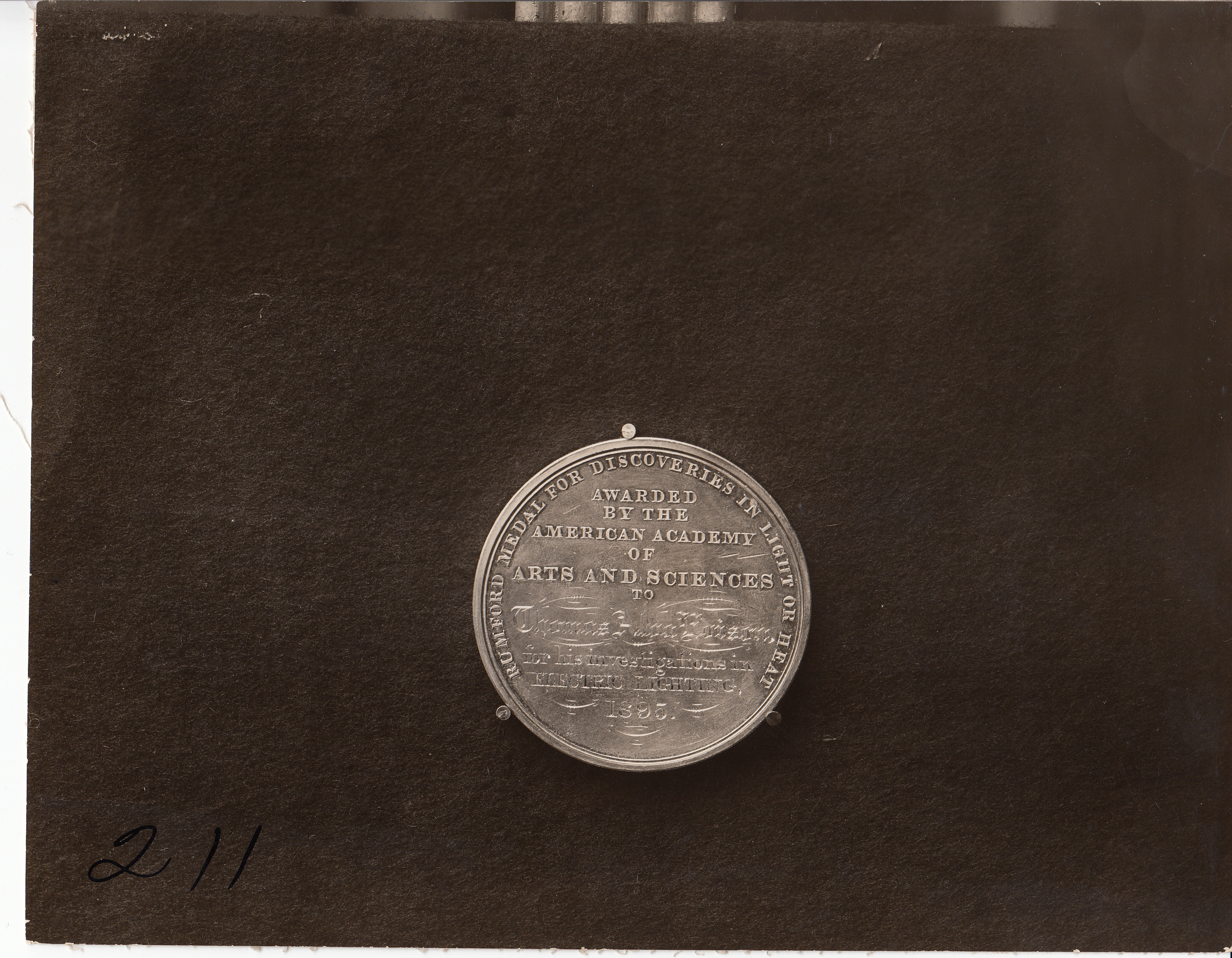 Benjamin Count Rumford medal (1895) for discoveries in light or heat, inscription side.