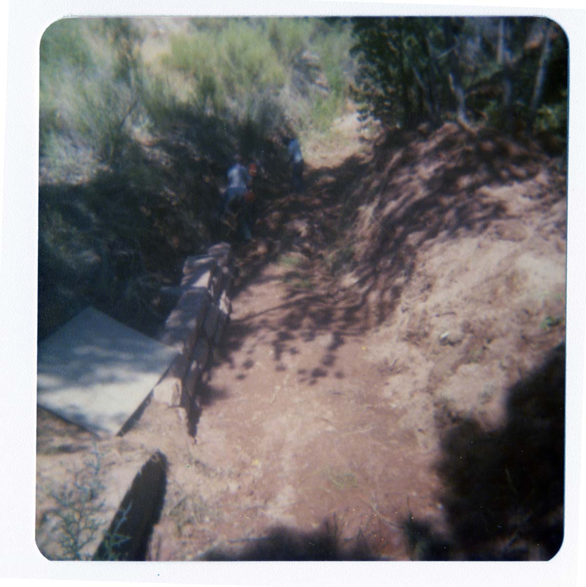 Four men working on section of trail near new Grotto footbridge.