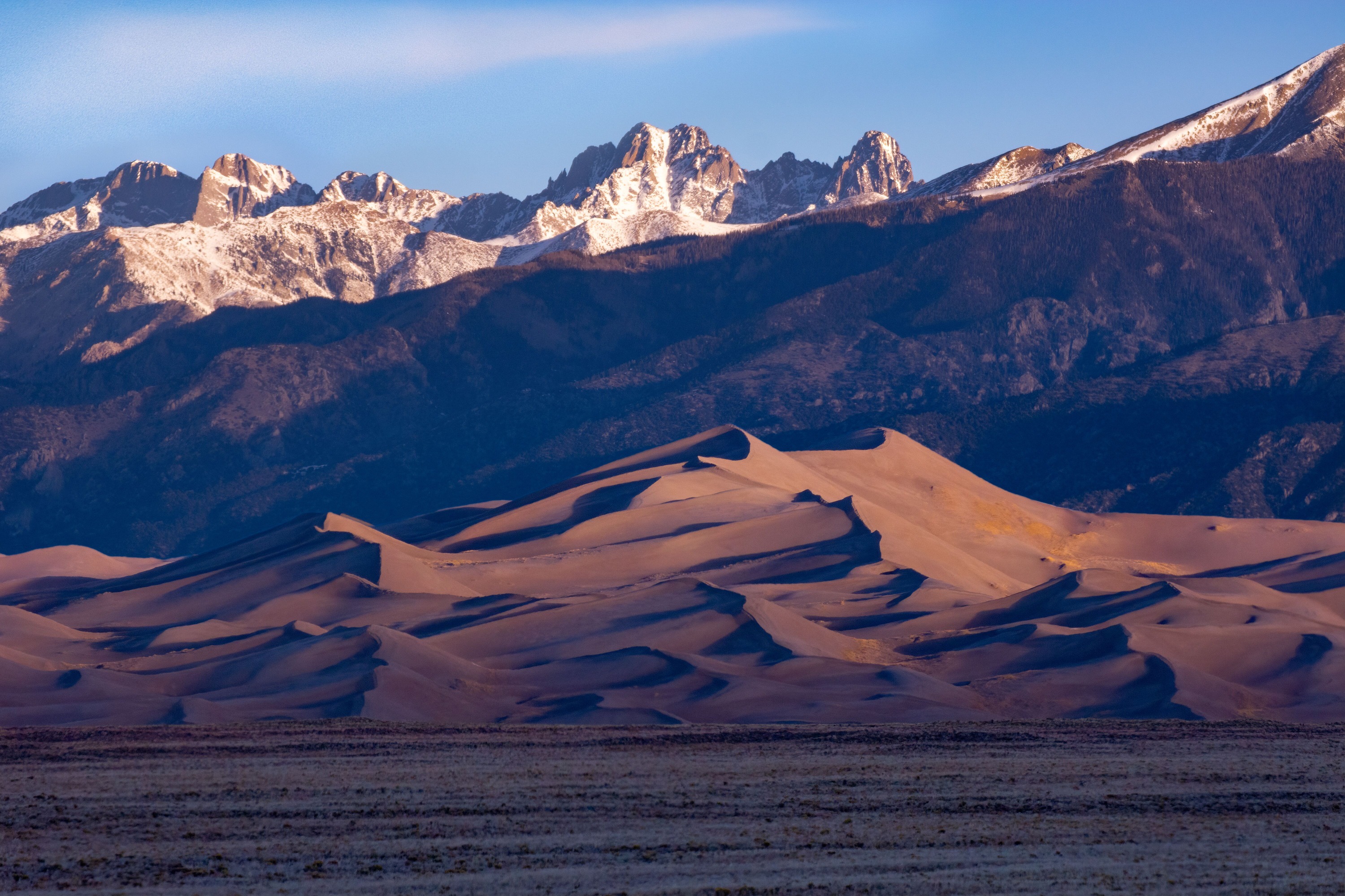 Pyramid-Shaped Star Dune and Jagged Crestone Peaks in Morning Light