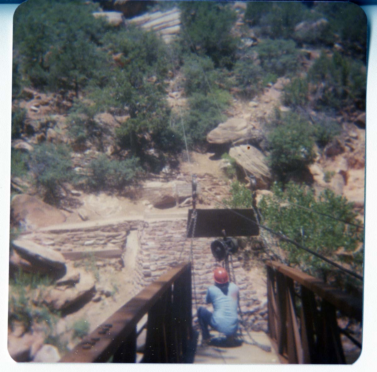 Man rigging the pulley system to move the new Grotto footbridge into place across the Virgin River.