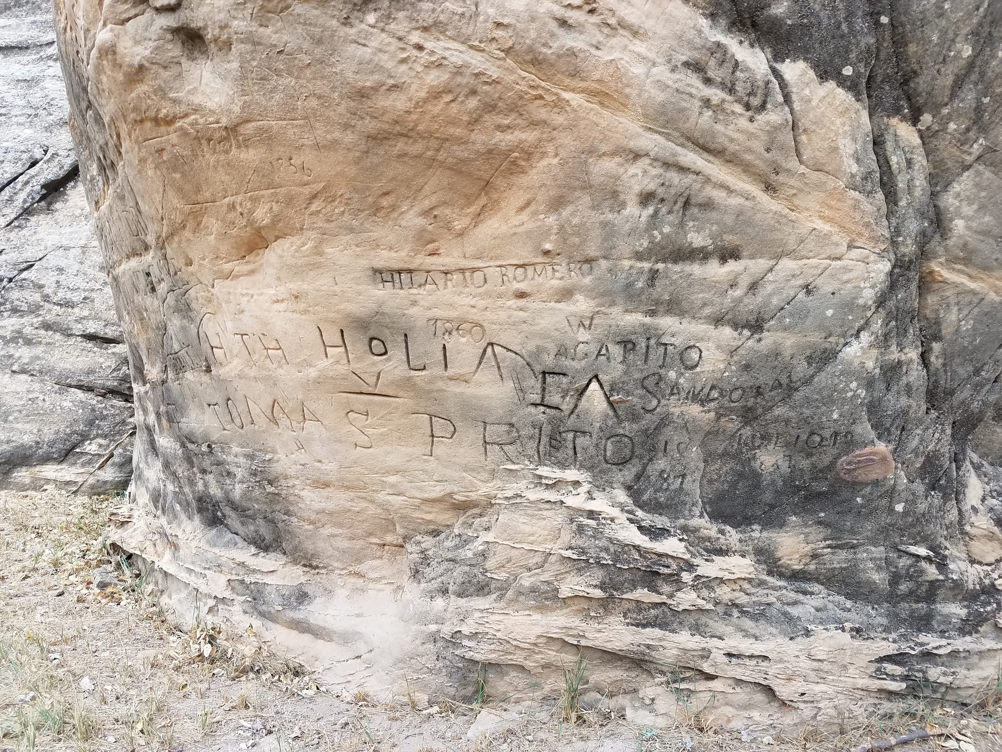 A large rock with writing on it.