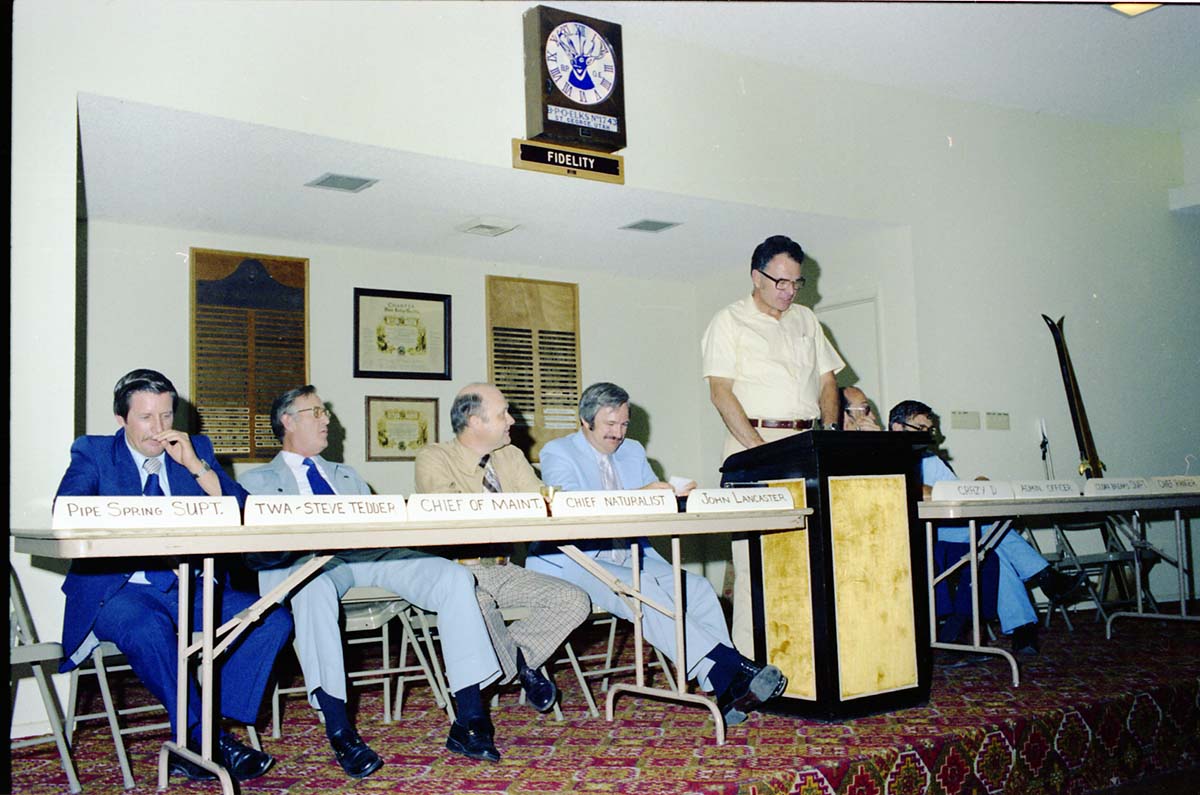 Color Photos of John Lancaster's farewell party at Elks Club in St. George, Utah. Speakers at roast in front of room: Pipe Spring National Monument Superintendent, TWA Steve Tedder, Chief of Maintenance, Chief Naturalist, John Lancaster, Crazy D, Administrative Officer, Cedar Breaks National Monument Superintendent, Chief Ranger, Unknown Skier.
