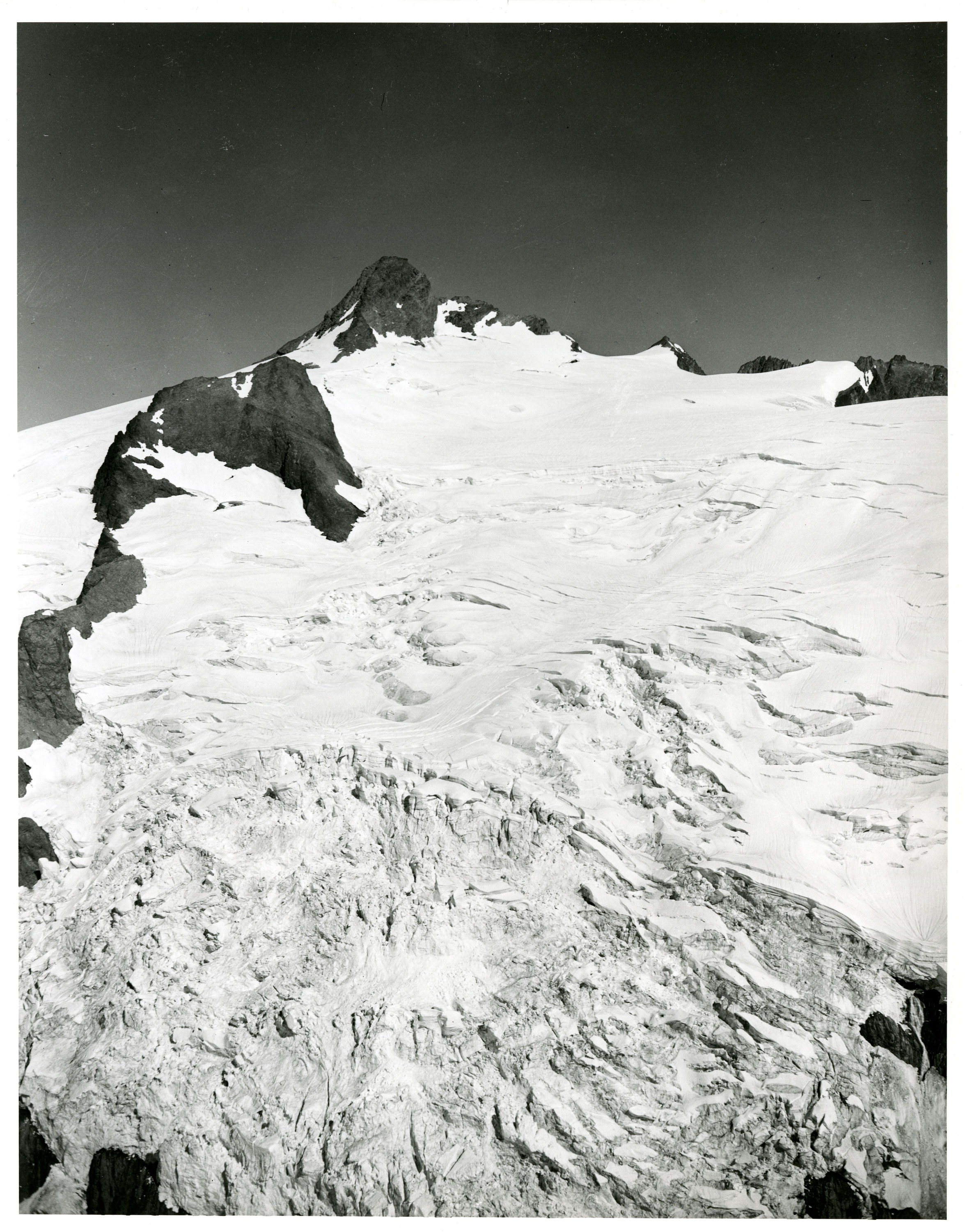 Glacier cascading down a mountain peak.