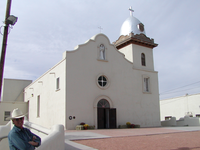 A man standing in front of a church.