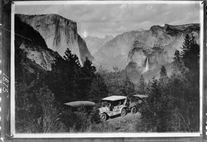 First regular autostage into Yosemite Valley. Mr. Edwin T. Huffman on June 2, 1915, drove the first auto stage of Yosemite Stage and Turnpike Co. into Yosemite Valley over the Wawona Road. This picture taken at that time by Julius Theodore Boysen marked passing of horsedrawn stage.