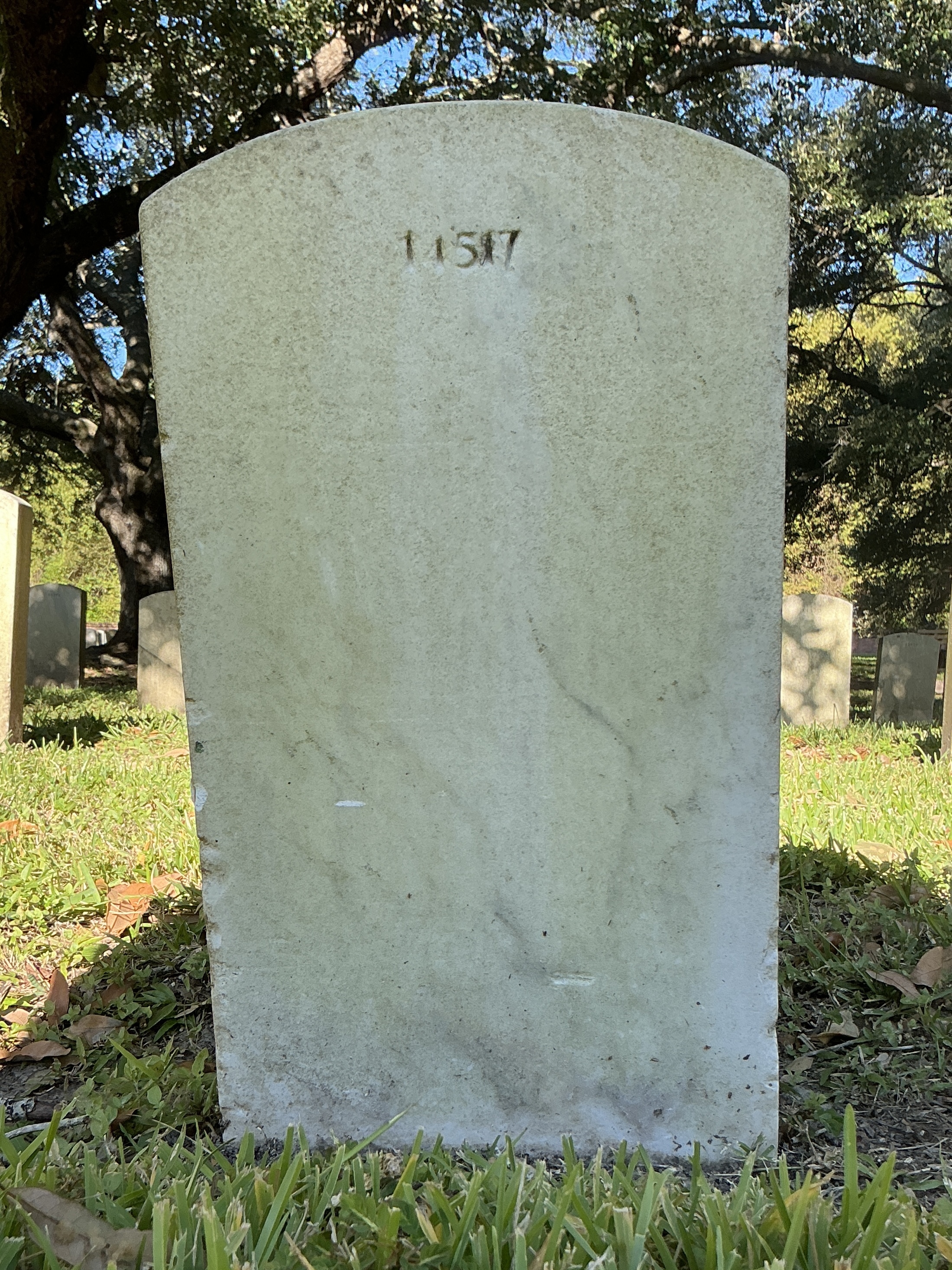 Back of upright marble headstone with flat face.