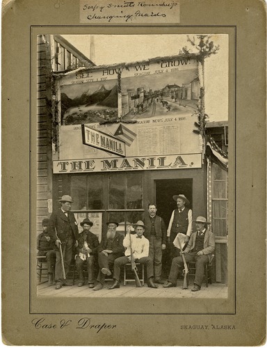 Historic Sepia photo of men outside of a old Saloon in Skagway, AK