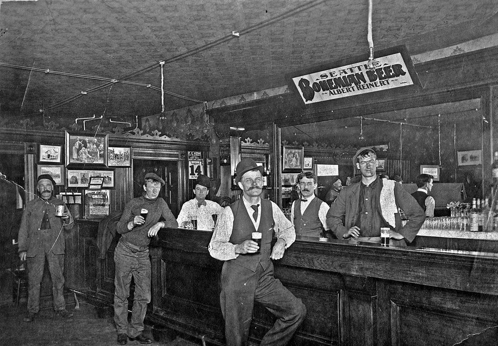 Historic Black and White image of men standing the 1916 Mascot Saloon