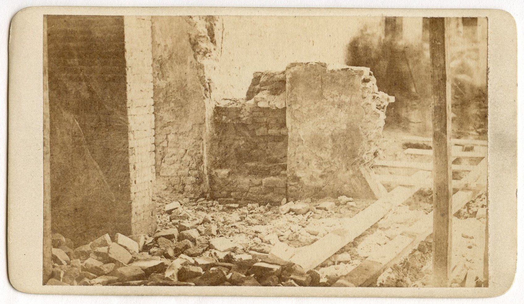 Close-up of brick building, a ruined brick wall, and rubble.