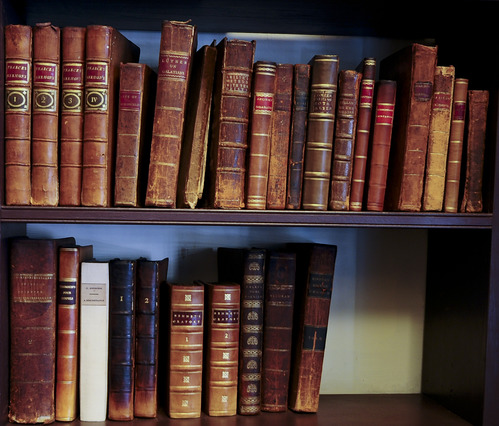 A color photo of showing some of the original books in Bishop White's study.