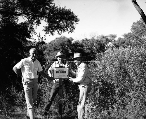 Springdale Mayor Austin Excell, Lions Club President Earl Mansor, and Lions Club member Dewey Excell posting Bird Refuge sign at the Springdale ponds (private property).