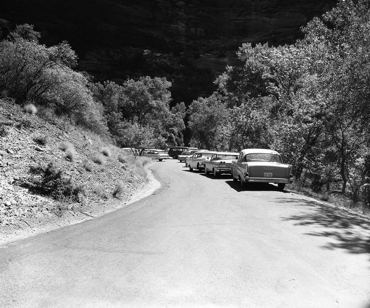 Visitor use - Weeping Rock parking area, parking area filled to capacity, 52 cars counted. Cars parked on road.