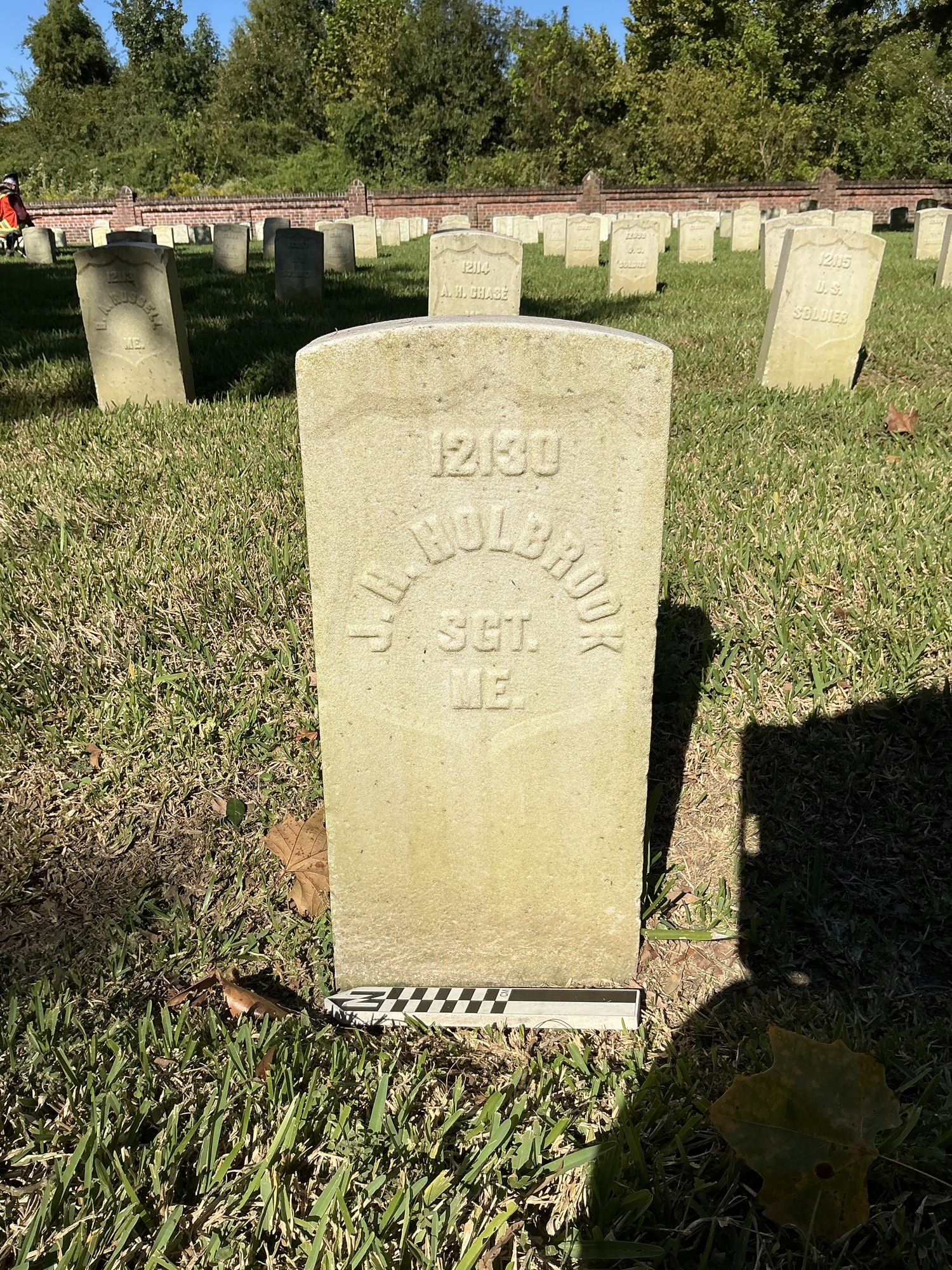 Extra image of historic upright marble headstone with recessed shield face.