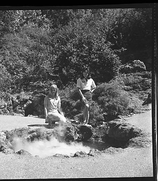 Ms. Krenzelok & possibly a volunteer posing near display spring behind Maurice Bathhouse. Similar to HOSP 10466.
