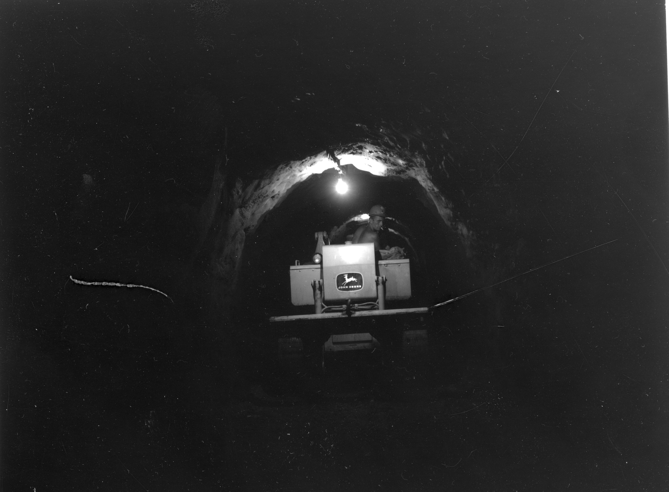 Tractor in dark stone tunnel 