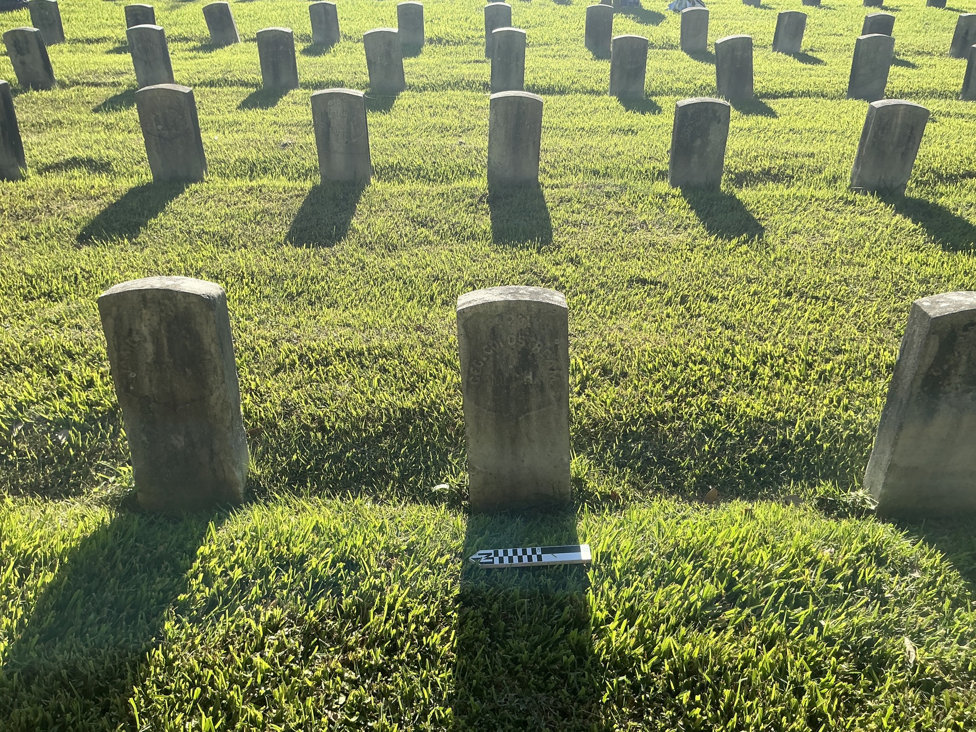 Extra image of historic upright marble headstone with recessed shield face.