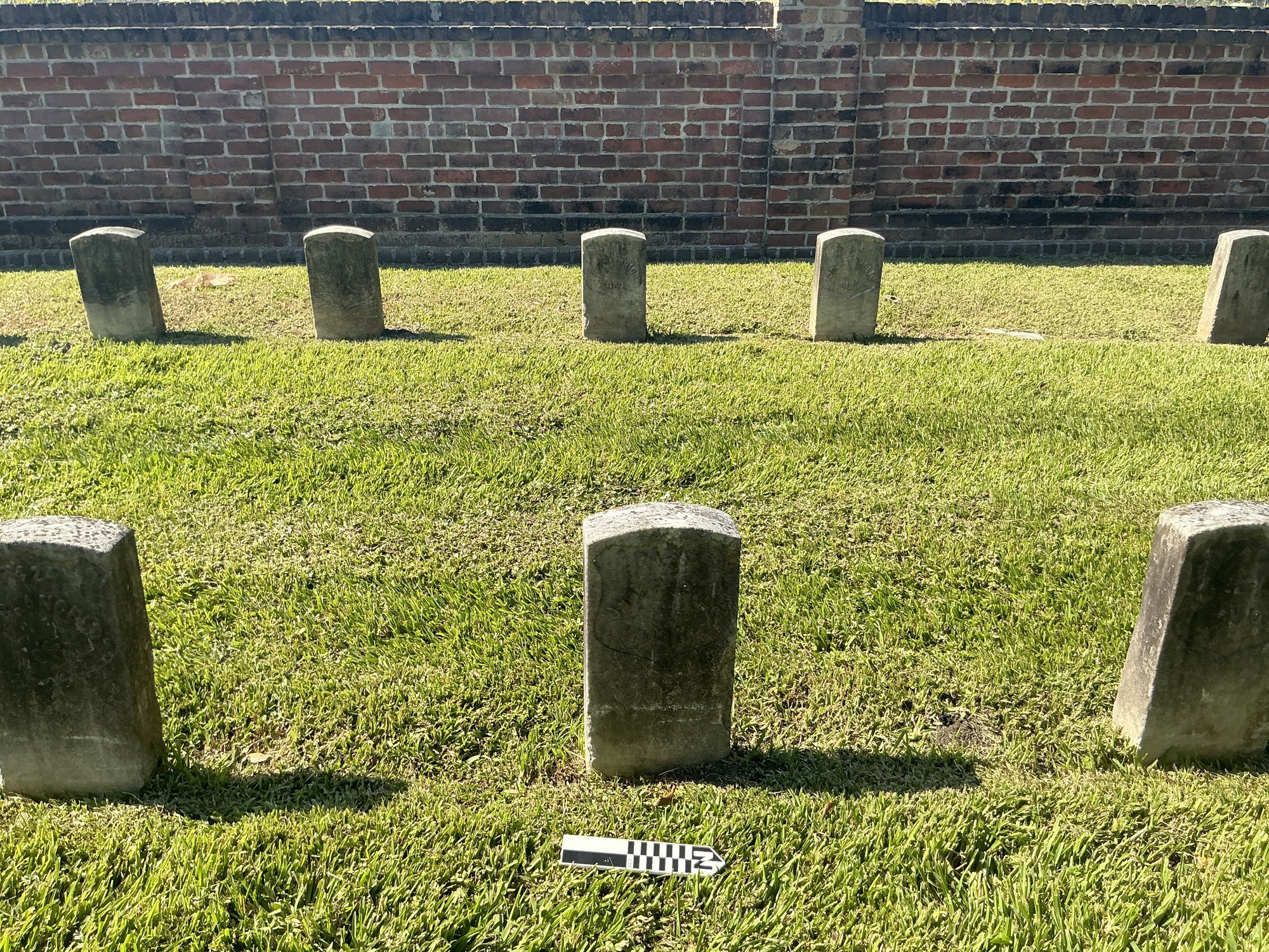 Extra image of historic upright marble headstone with recessed shield face.