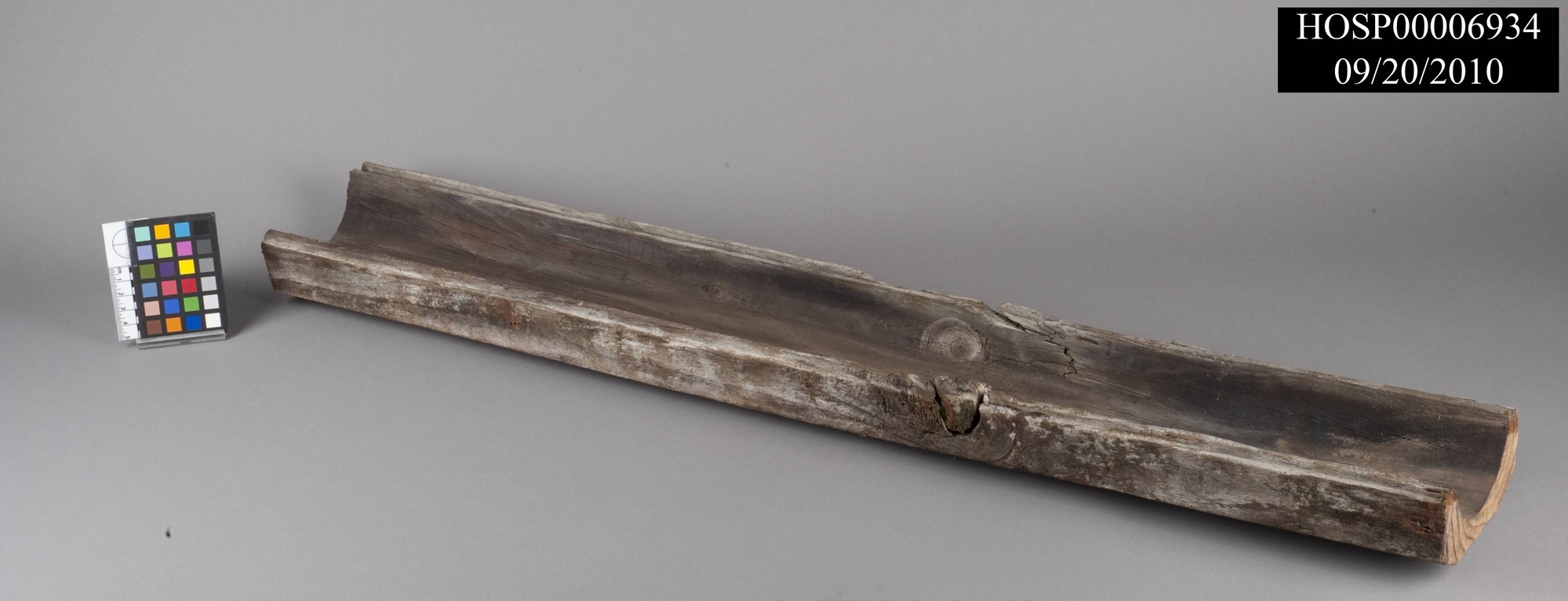 Cypress water pipe insulator; Hand hewn half-diameter section of cylindrical cypress water pipe insulator with tongue & groove joints running along both long edges; originally two pieces would have been fitted together around a thermal water pipe, insulating it to keep water hot as it ran underground to the Rector Bathhouse on the west side of Central Avenue, completed in April 1894.