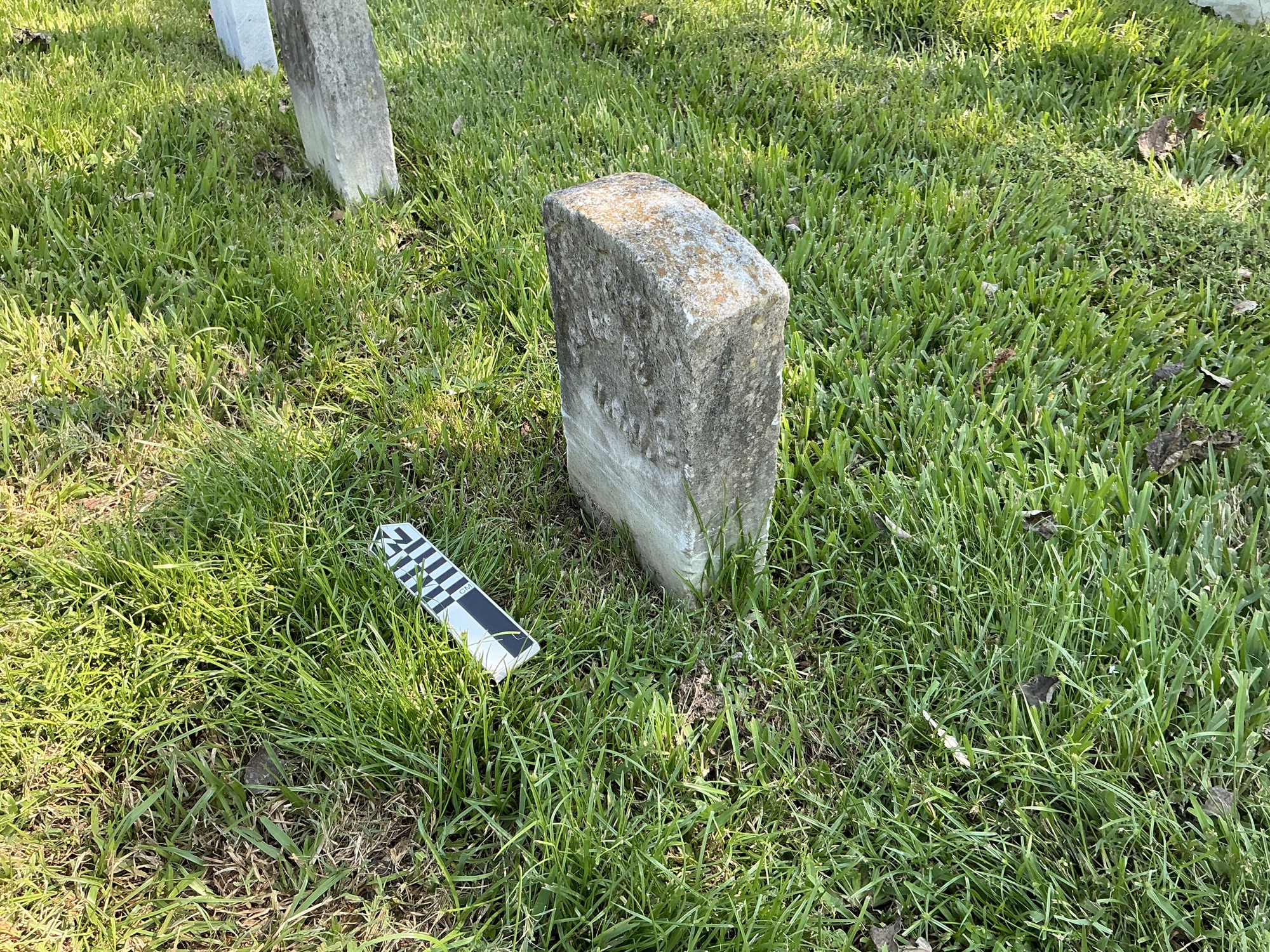 Extra image of historic upright marble headstone with recessed shield with recessed lettering face.