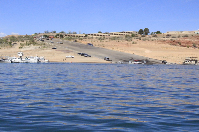 Paved steep launch ramp where trucks with trailers are launching or retrieving boats. 