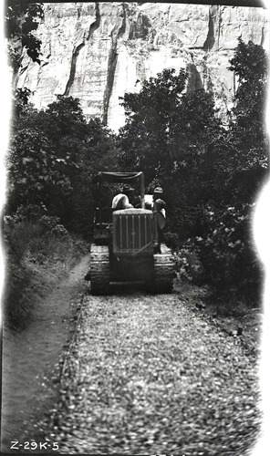 Narrows Trail construction with a view of workers on a caterpillar tractor rolling the base.