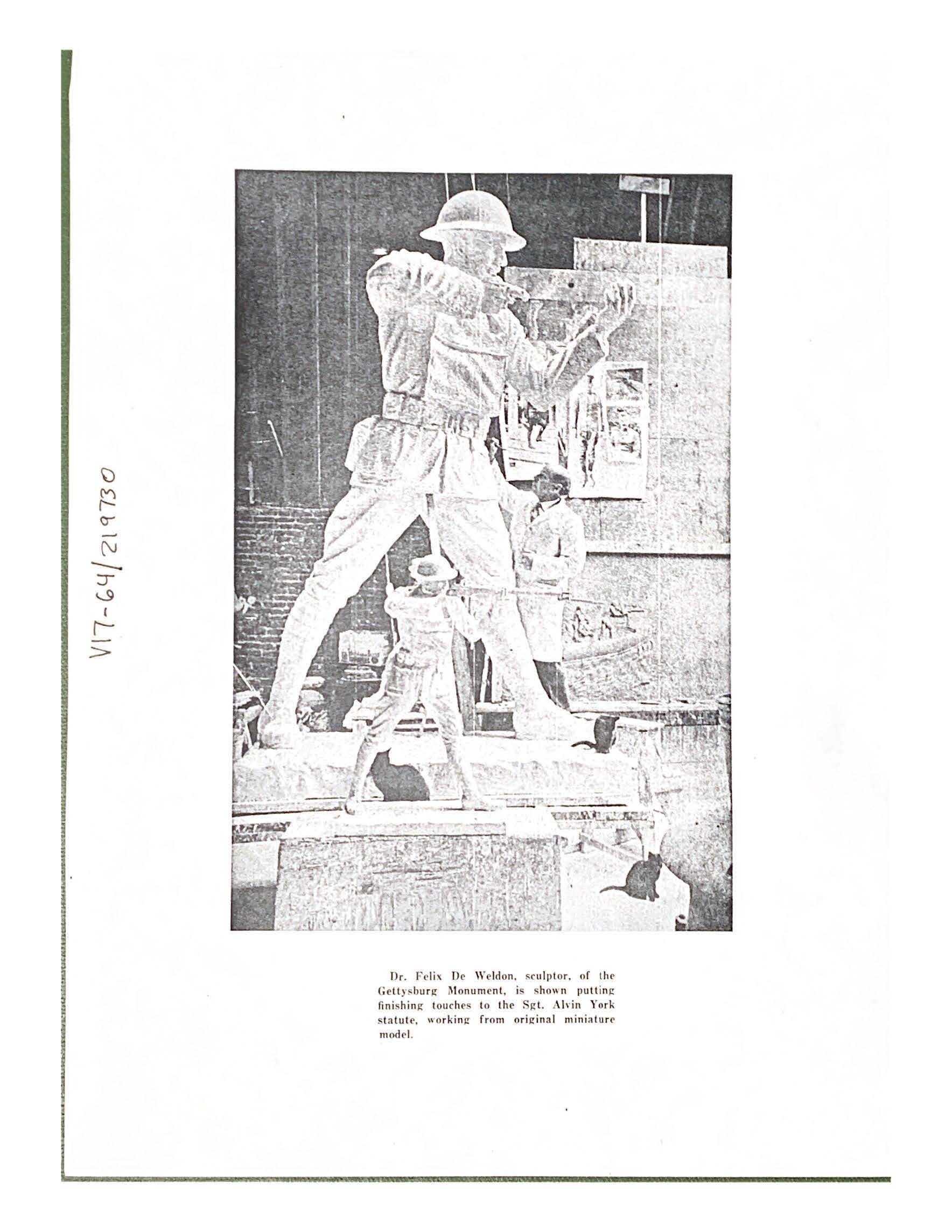 Dr. Felix De Weldon, sculptor, of the Gettysburg Monument, is shown putting finishing touches to the Sgt. Alvin York statue, working from original miniature model.