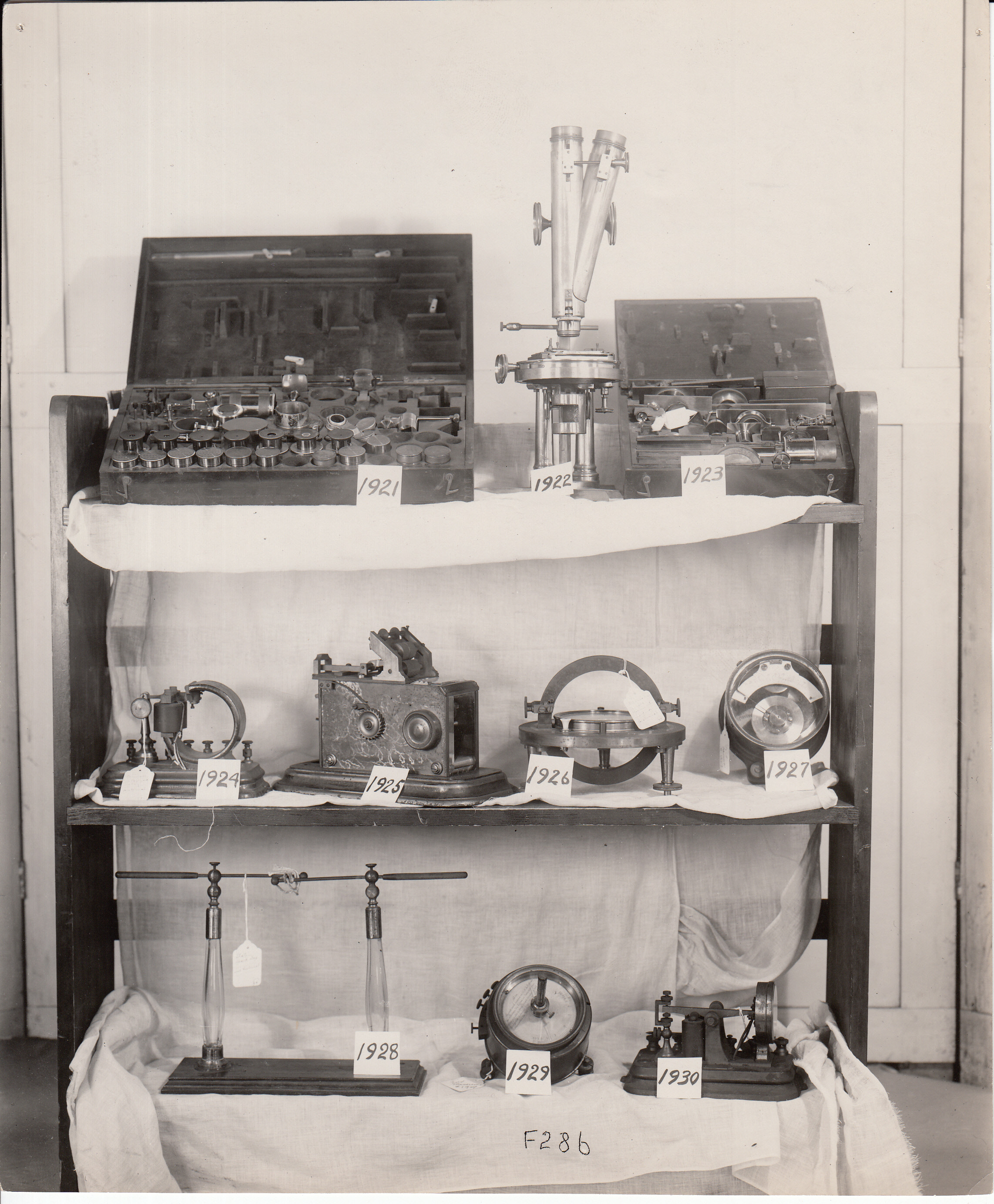 Shelves of numbered Edison artifacts sent to the Henry Ford Museum, Dearborn, Michigan, including microscope, printing telegraph, galvanometer, and voltmeter.