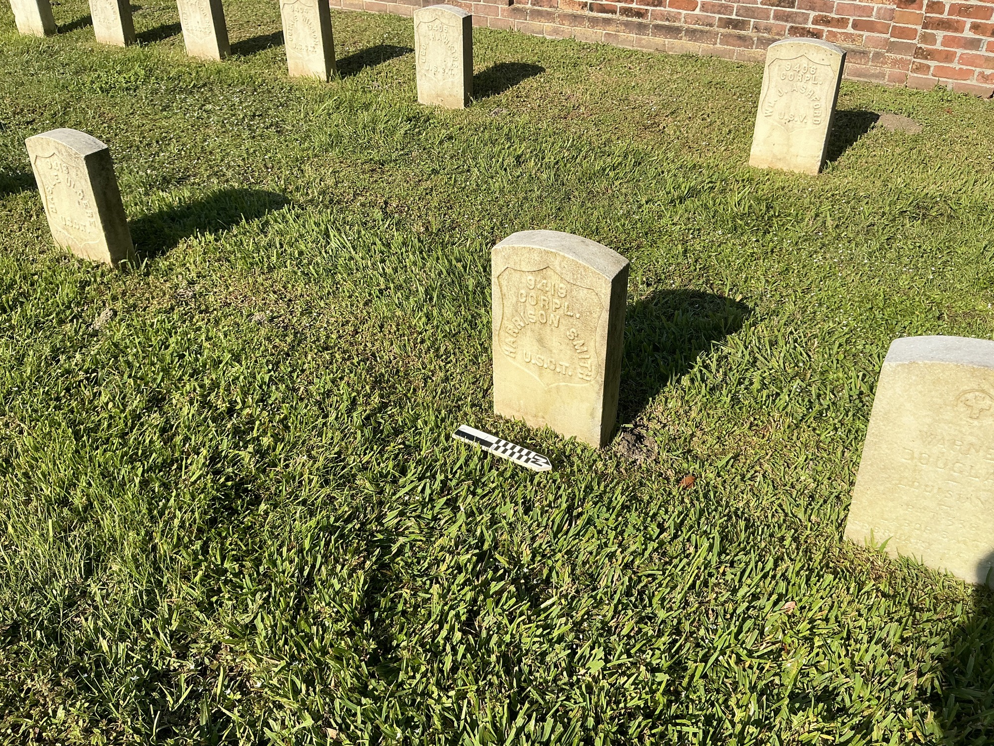 Extra image of historic upright marble headstone with recessed shield face.