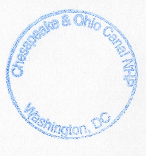 A blue, circular stamp with "Chesapeake & Ohio Canal NHP" on the top and "Washington, DC" on the bottom.