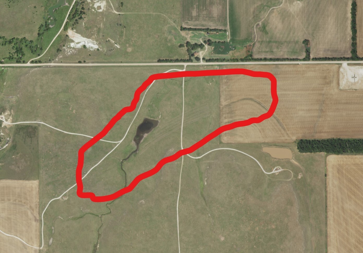 A red marked area in the middle of a field.