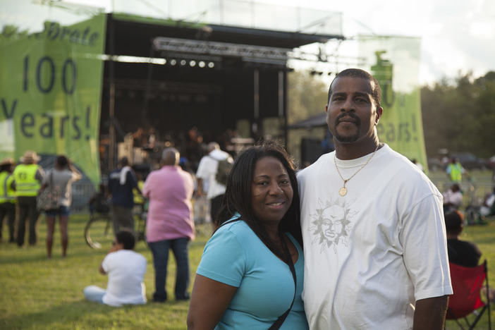 A couple pose for the camera in front of the music stage at Anacostia Park.