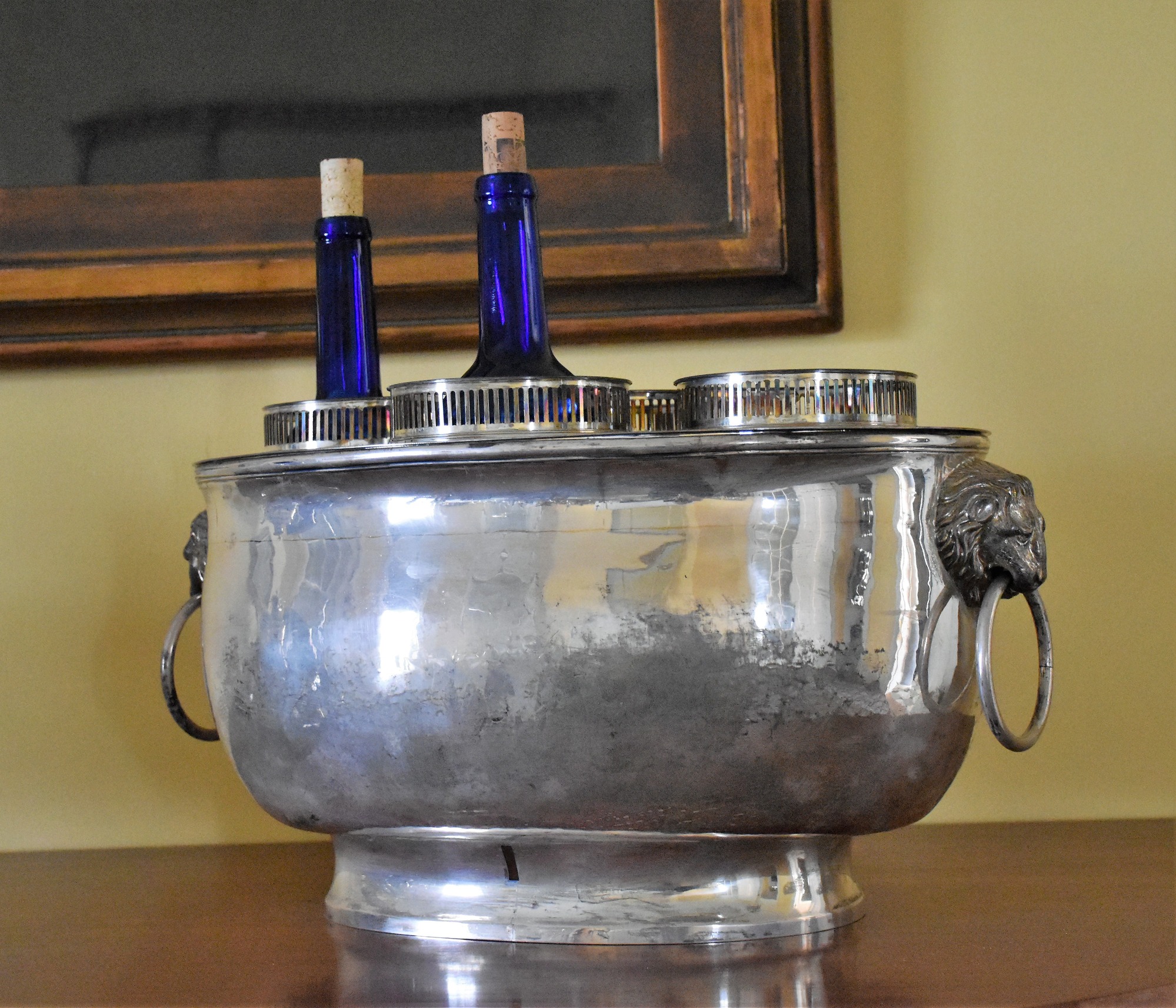 A silver wine cooler with two wine bottles inside.
