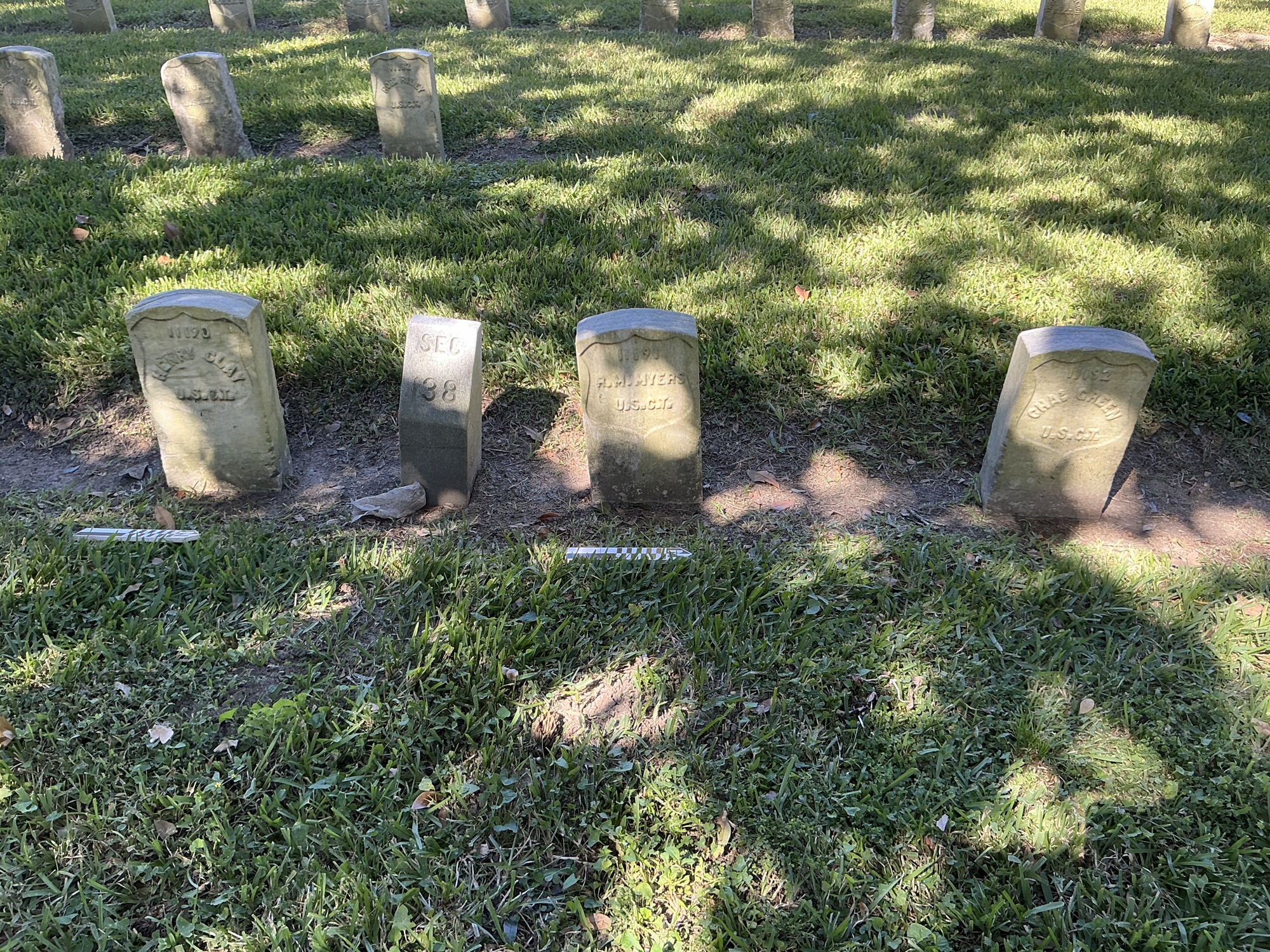 Extra image of historic upright marble headstone with recessed shield face.