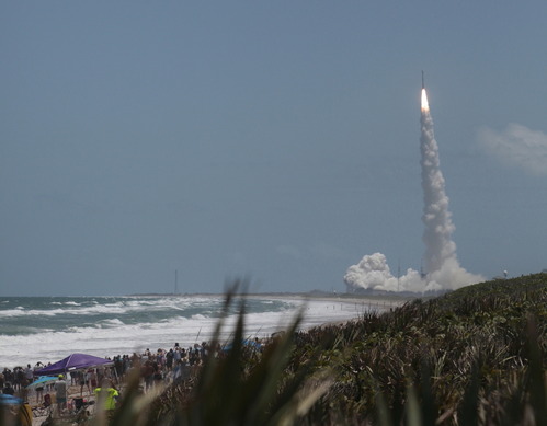 A rocket launch with the beach in the foreground.