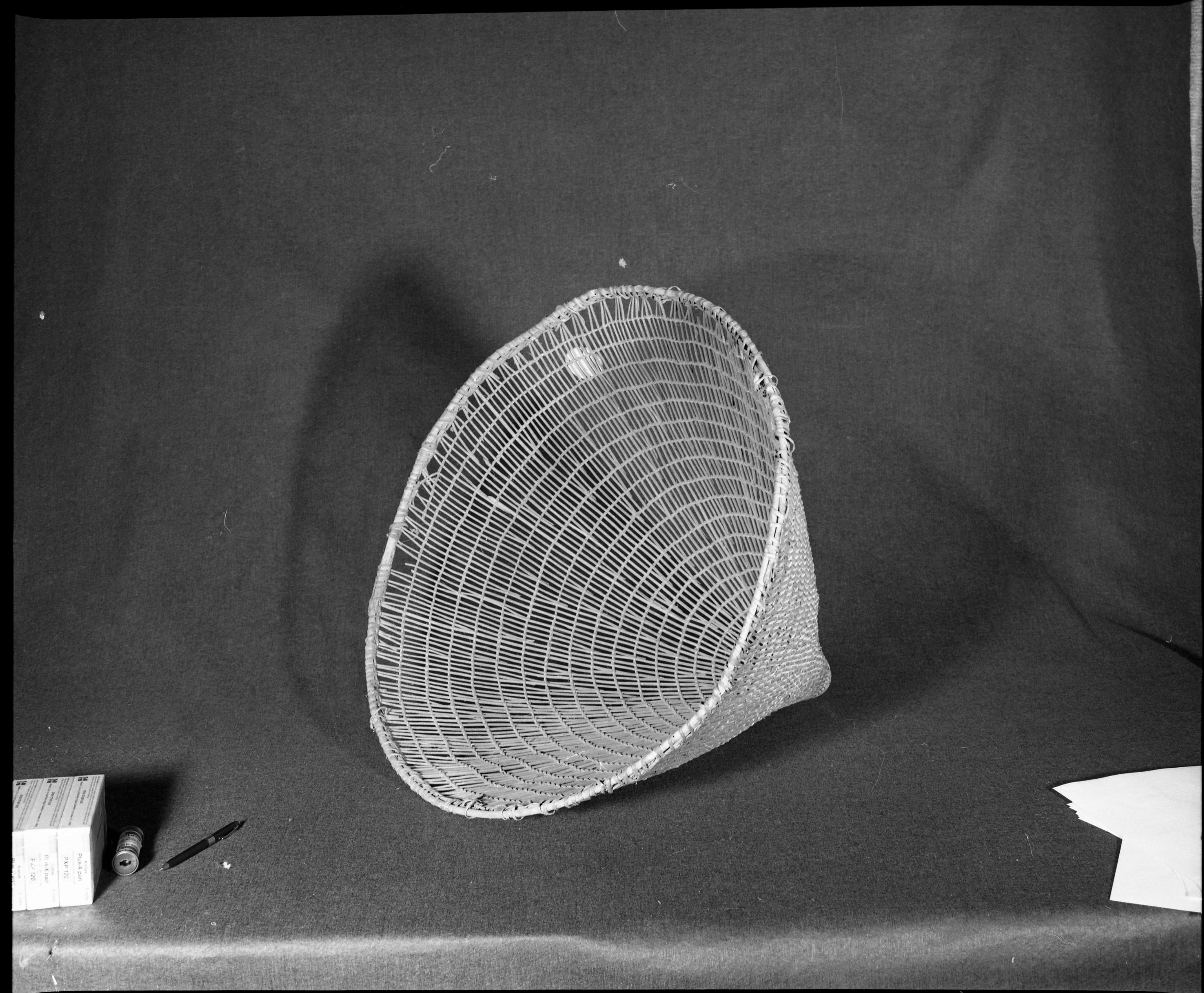 Marie Rozier Collection, Catalog No. 1. Object: Washoe burden basket. Dimensions: 24 x 22". Materials: Willow shoots, split willow. Technology: Plain twined, down to right slant of turns, rimstick bound on without the aid of an awl. Collection History: Acquired from Marion Steinbach. Photographed by Michael Dixon, December 1982. Catalogued by Craig Bates and Barbara Beroza. Yosemite Collections, National Park Service.