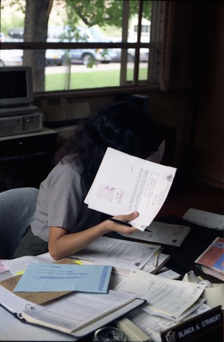 Color Photos of administration personnel. Blanca A. Stransky hiding behind memorandum.