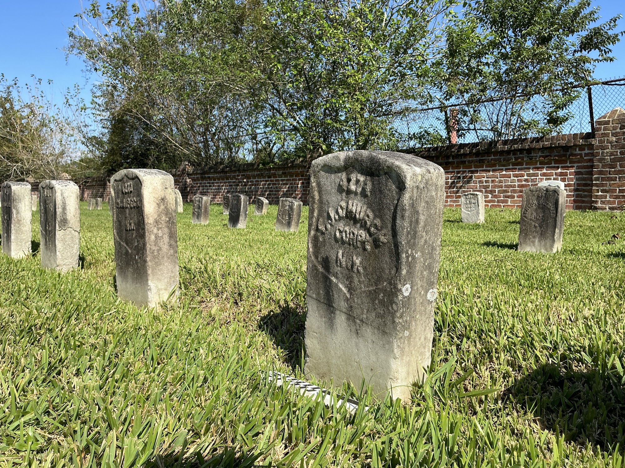 Extra image of historic upright marble headstone with recessed shield face.