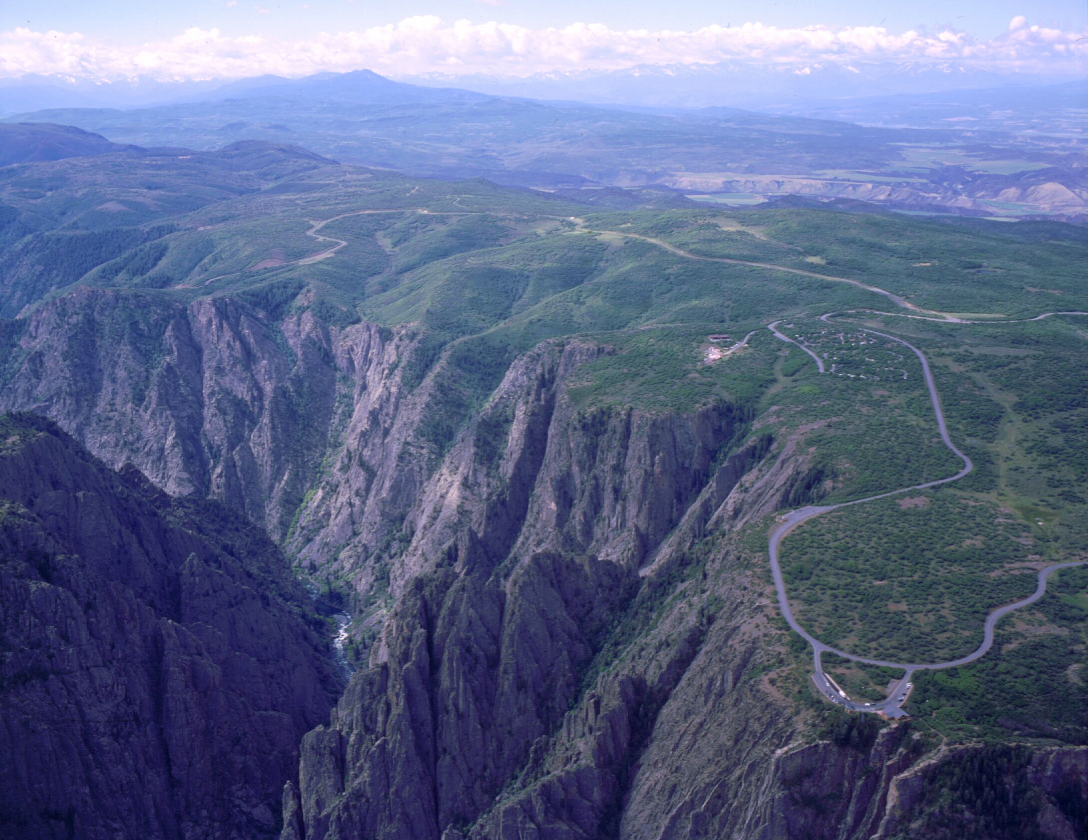 Aerial view of canyon with South Rim Visitor Center visible in bottom right